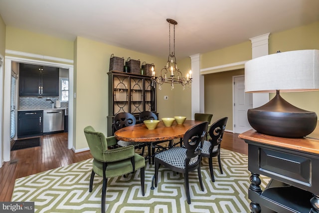 dining space featuring a chandelier and dark wood finished floors