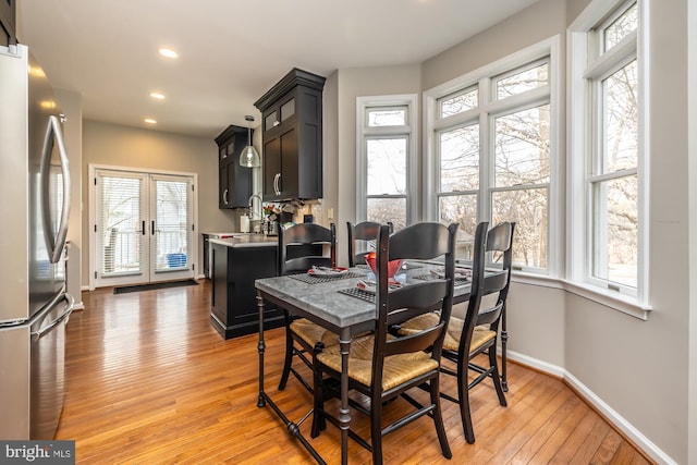 dining room with light wood-type flooring, french doors, baseboards, and recessed lighting