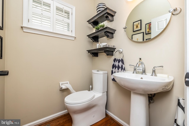 bathroom with baseboards and toilet