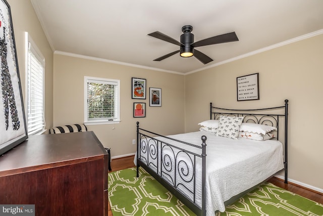 bedroom with ornamental molding, a ceiling fan, baseboards, and dark wood-style flooring