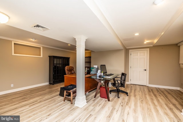 office with ornate columns, visible vents, baseboards, and wood finished floors