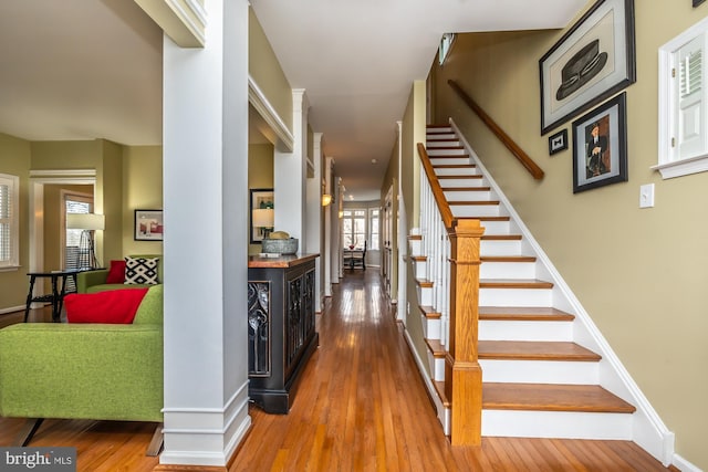 interior space with stairway, baseboards, and hardwood / wood-style flooring