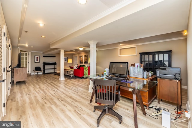 home office with decorative columns, light wood-style floors, and ornamental molding