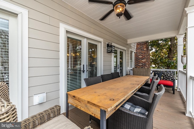 deck with outdoor dining space and a ceiling fan