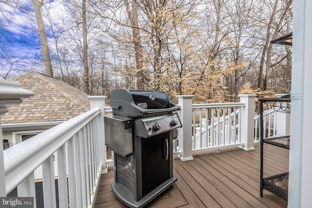 wooden deck with a grill