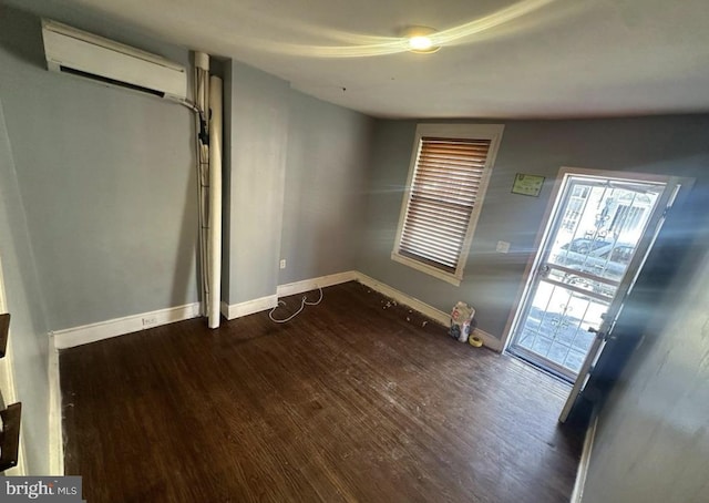 2837 Stouton St, Philadelphia, PA 19134 - interior space featuring a wall mounted air conditioner, wood finished floors, and baseboards