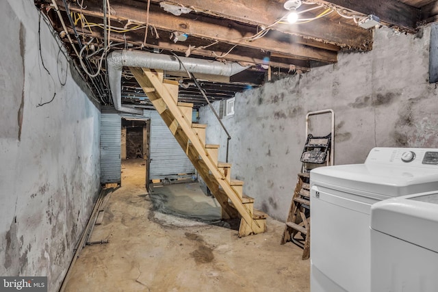 unfinished basement featuring washer / clothes dryer and stairs