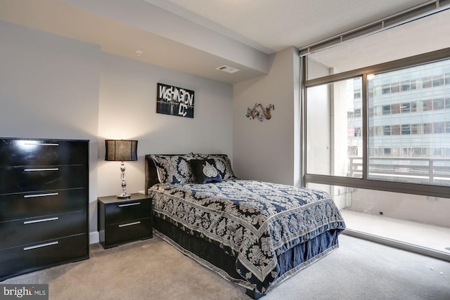 bedroom featuring light carpet and visible vents