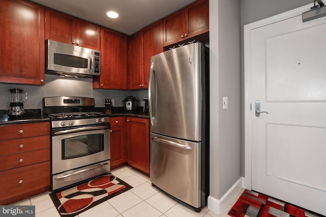 kitchen featuring stainless steel appliances, recessed lighting, baseboards, and light tile patterned floors