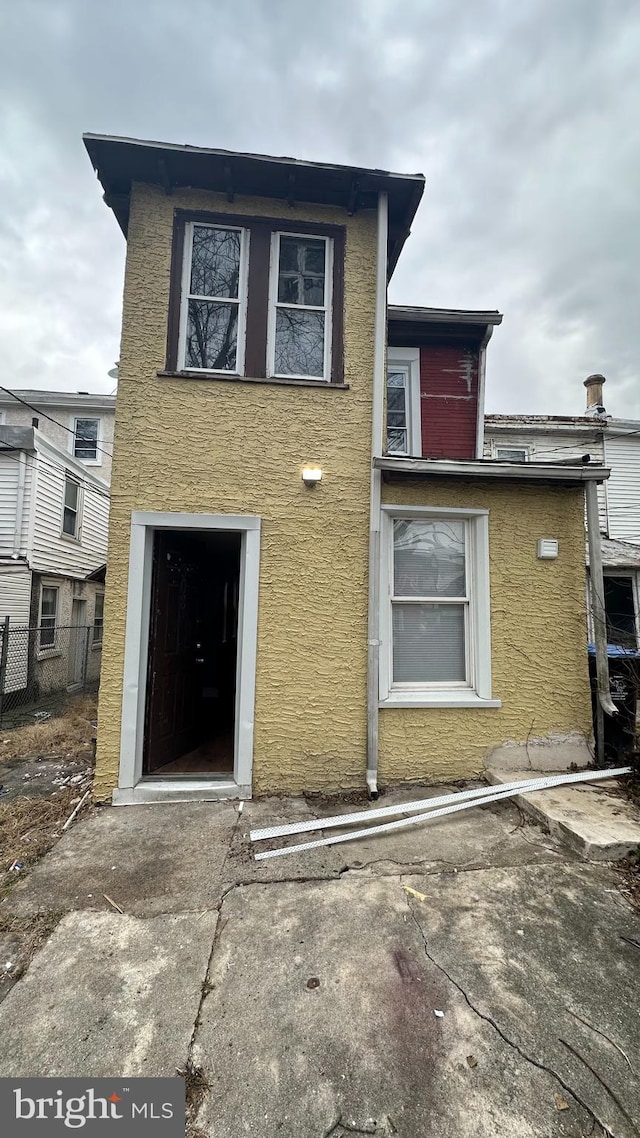 rear view of property with stucco siding