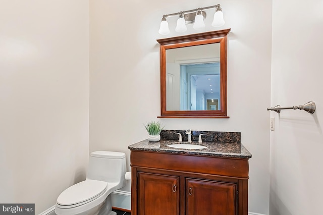 bathroom featuring toilet and vanity