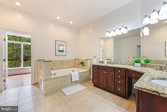 full bathroom with a garden tub, recessed lighting, vanity, and tile patterned floors