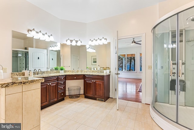 bathroom with a sink, visible vents, tile patterned floors, double vanity, and a stall shower