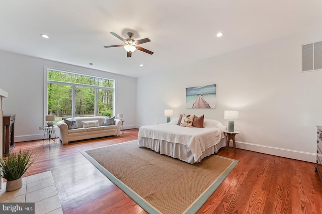 bedroom featuring baseboards, visible vents, and wood finished floors