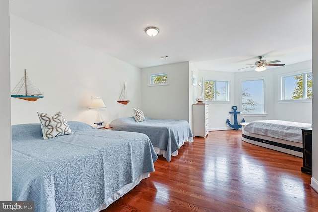 bedroom featuring multiple windows, visible vents, and wood finished floors