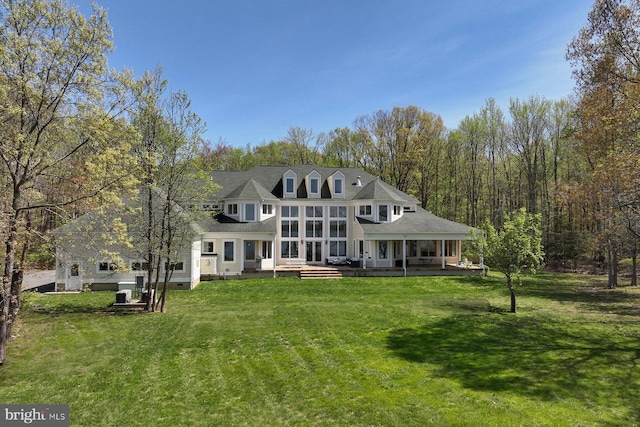 back of house with a lawn