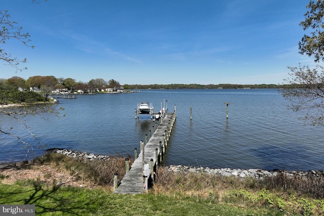 dock area with a water view and boat lift