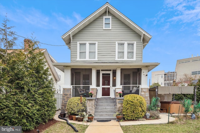 view of front facade with a porch and a hot tub