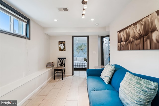 tiled living area with visible vents, recessed lighting, and baseboards