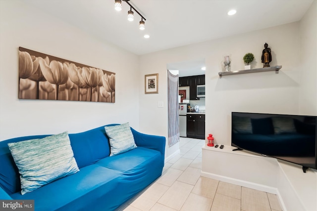 tiled living area with rail lighting, recessed lighting, and baseboards