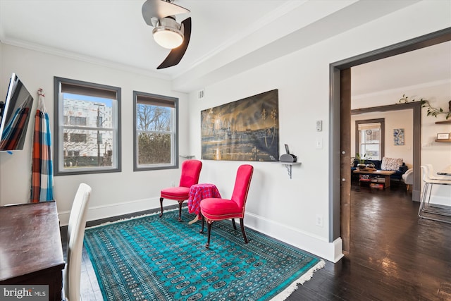 sitting room featuring baseboards, crown molding, a ceiling fan, and wood finished floors