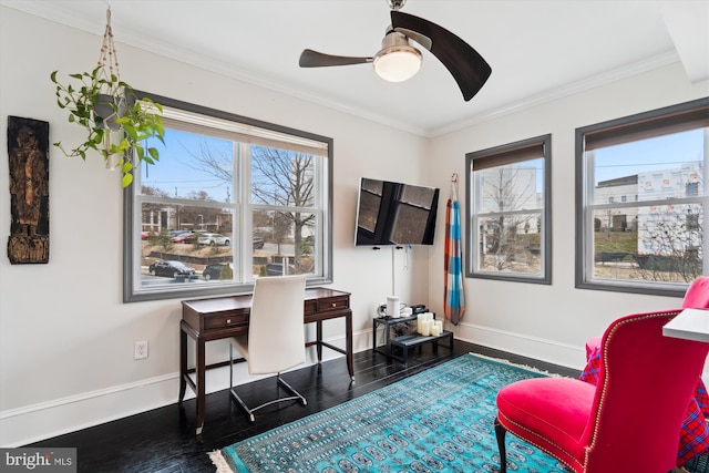 office space with baseboards, crown molding, ceiling fan, and wood finished floors