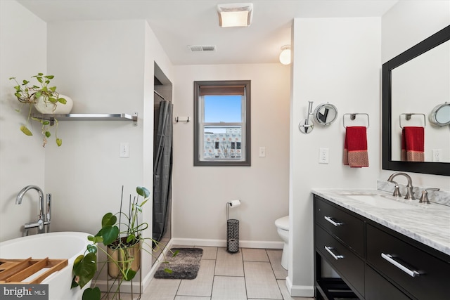 full bath featuring tile patterned floors, visible vents, toilet, a freestanding bath, and vanity