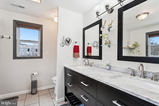 full bathroom with a sink, visible vents, toilet, and double vanity