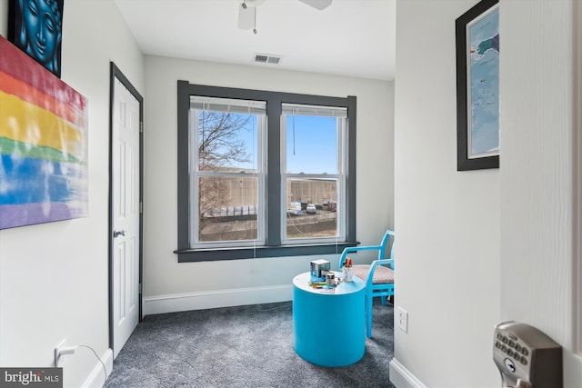 interior space with ceiling fan, carpet, visible vents, and baseboards