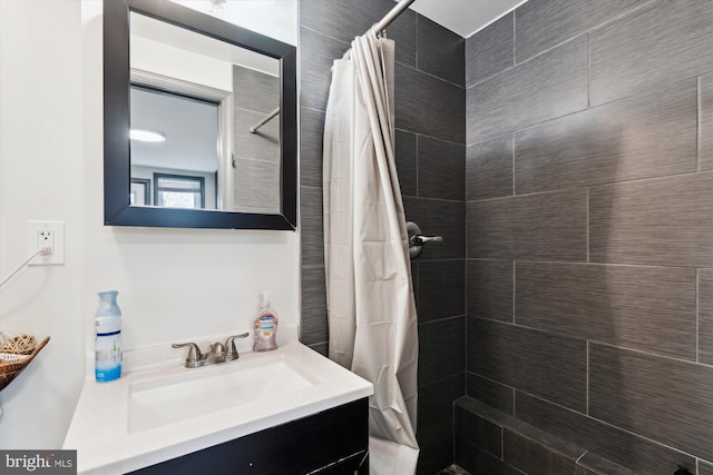 full bathroom with vanity and tiled shower