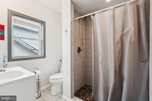 bathroom featuring tile patterned floors, toilet, and tiled shower