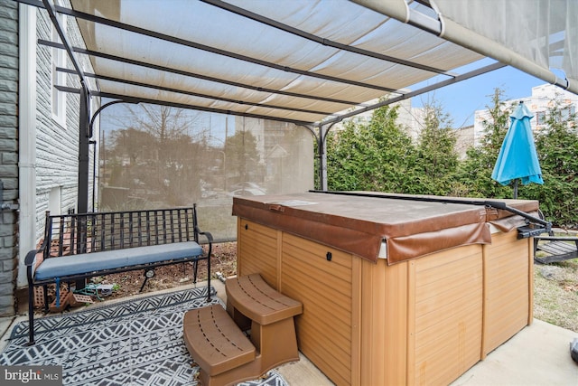 view of patio / terrace with a pergola and a hot tub