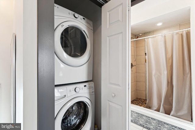 washroom with stacked washer and clothes dryer and laundry area