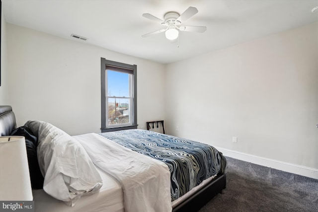 carpeted bedroom featuring visible vents, baseboards, and a ceiling fan