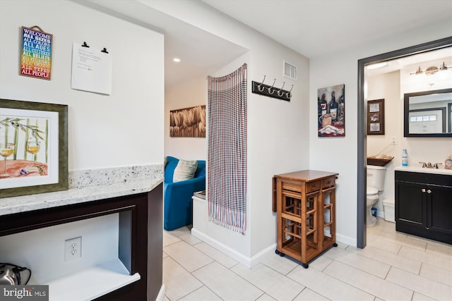 bathroom with visible vents, baseboards, toilet, and vanity