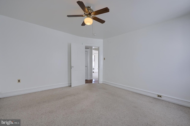 unfurnished room with ceiling fan, speckled floor, and baseboards