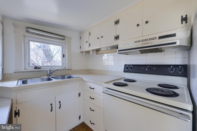 kitchen featuring white range with electric cooktop, tasteful backsplash, white cabinets, a sink, and under cabinet range hood