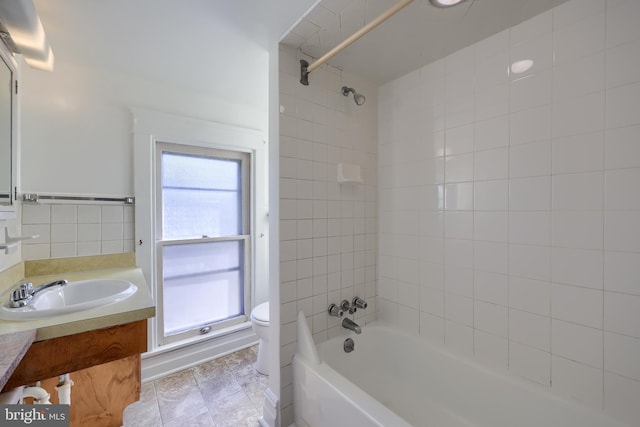 bathroom featuring vanity, shower / tub combination, and toilet