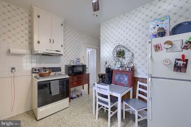 kitchen featuring wallpapered walls, under cabinet range hood, white cabinetry, and white appliances