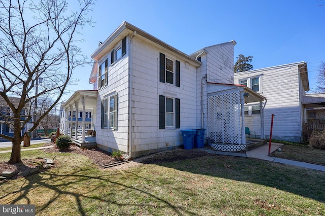 view of side of home with a lawn