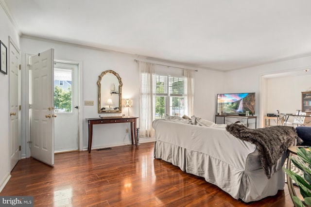 bedroom featuring dark wood-style floors, multiple windows, visible vents, and crown molding