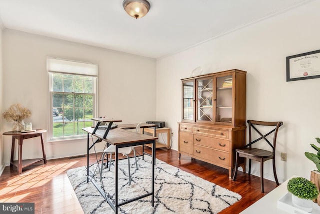 home office with visible vents, baseboards, and wood finished floors