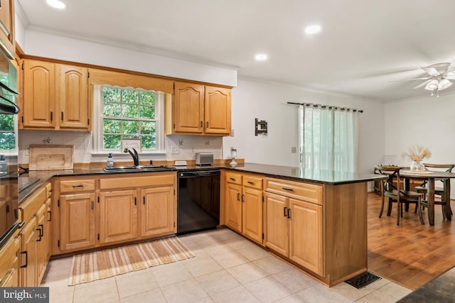 kitchen with black dishwasher, backsplash, ornamental molding, a sink, and a peninsula