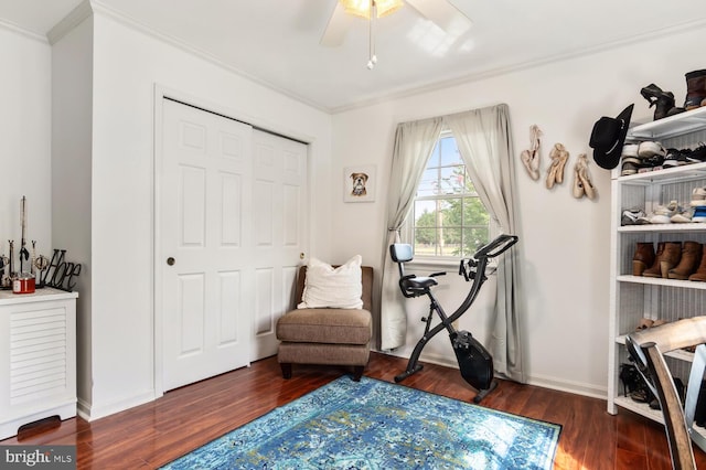 sitting room featuring ornamental molding, ceiling fan, baseboards, and wood finished floors