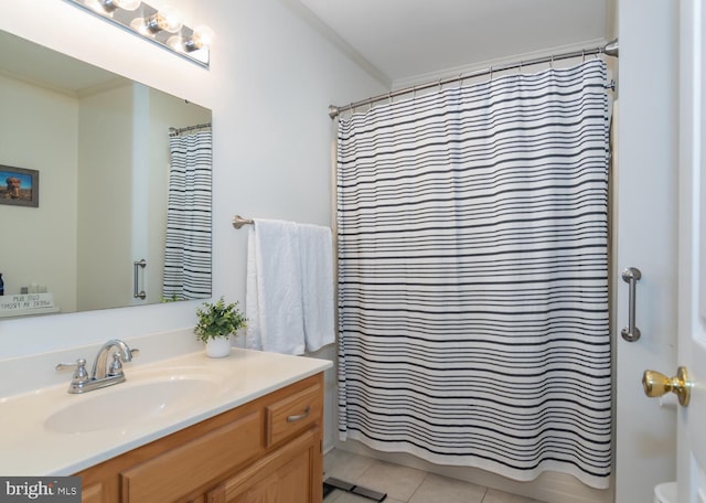 full bathroom featuring toilet, vanity, ornamental molding, and tile patterned floors