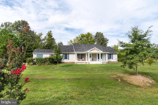 ranch-style home with covered porch and a front yard