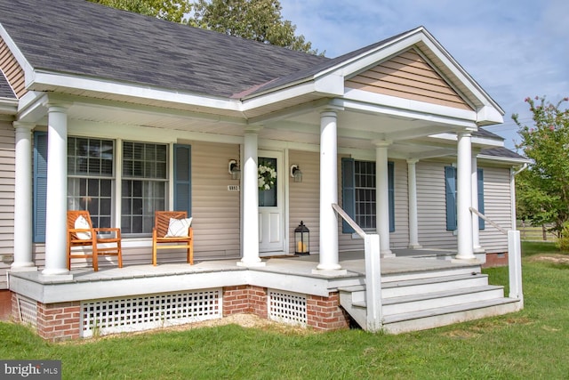 view of front of house with covered porch and a shingled roof