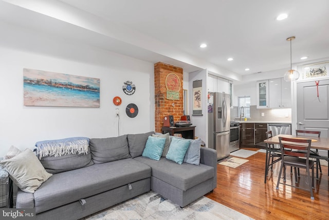 living area with recessed lighting and light wood finished floors