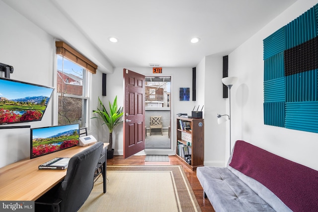 office space with baseboards, wood finished floors, and recessed lighting