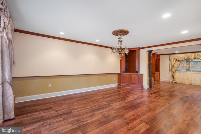 unfurnished living room featuring crown molding, recessed lighting, wood finished floors, and a notable chandelier